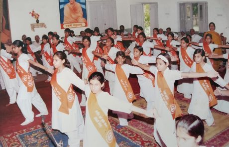 Focused girls in yoga poses — at the Arya Samaj campus.